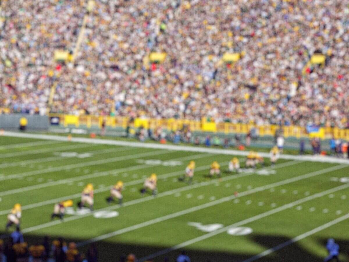 The offensive line at an American football game preparing for a kickoff.