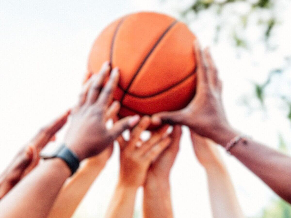 hands holding up a basketball