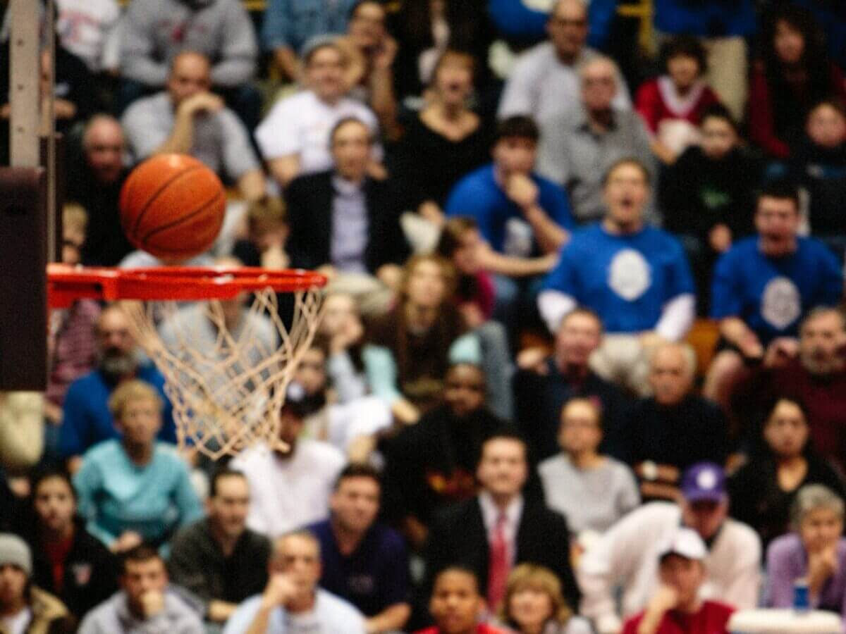 A basketball about to fall into the net