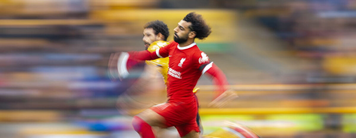 Liverpool soccer player outrunning an opponent