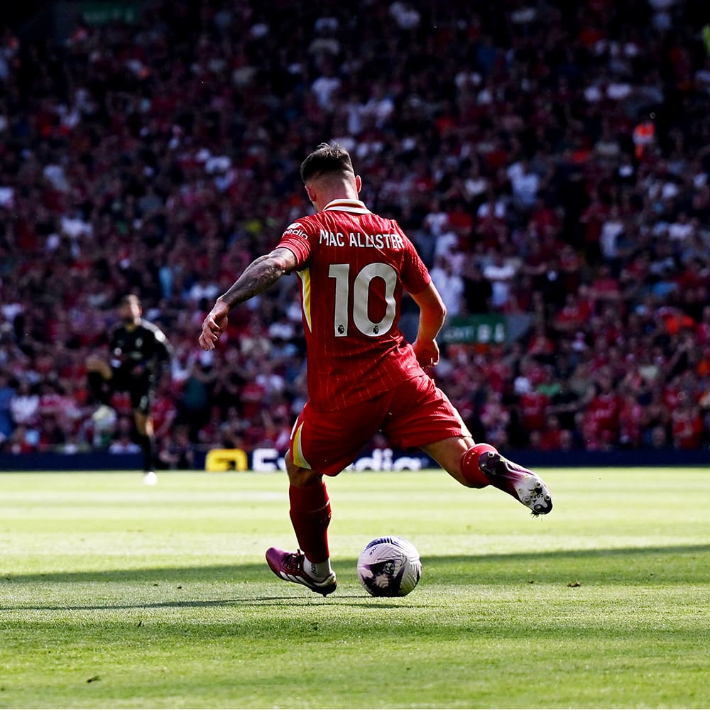 Liverpool player kicking the ball