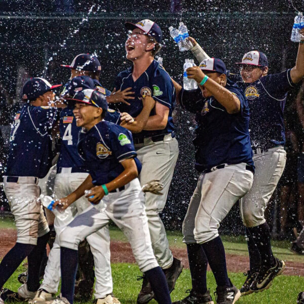 Youth baseball players celebrating a win